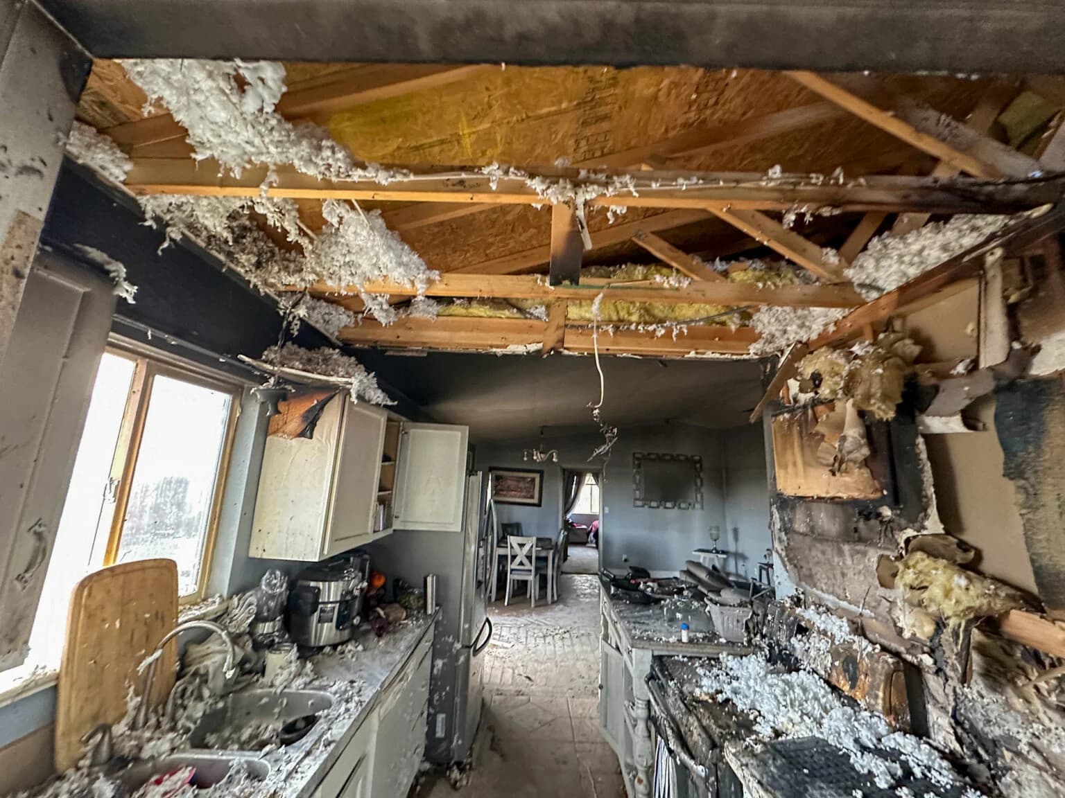Restoration professional cleaning smoke and fire damage inside a property