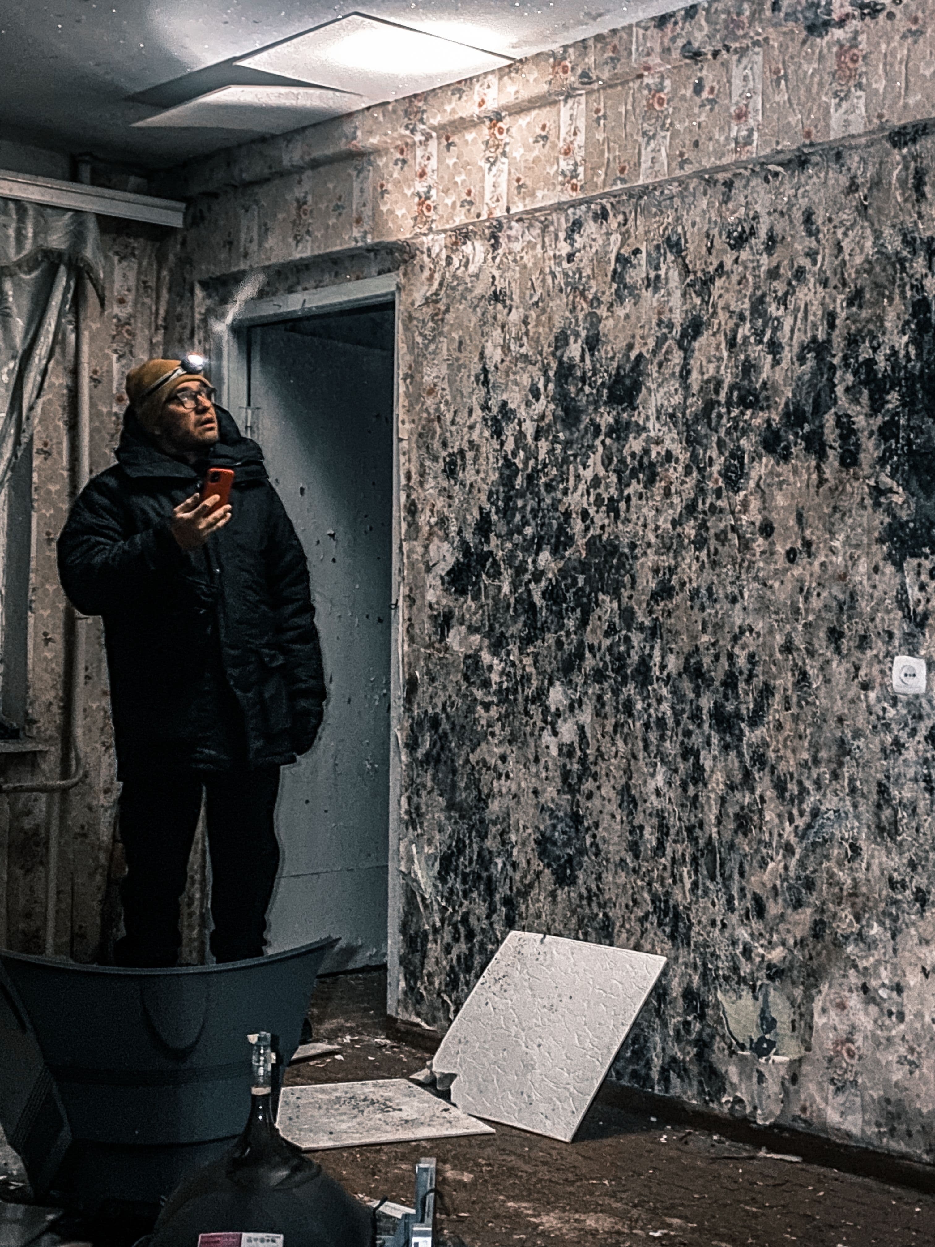 Mold remediation professional inspecting and treating an affected property