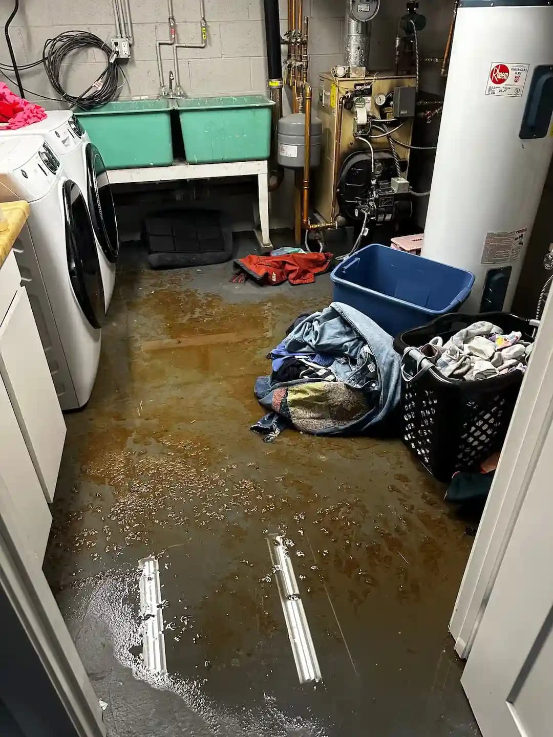 Restoration technician extracting water from a damaged floor